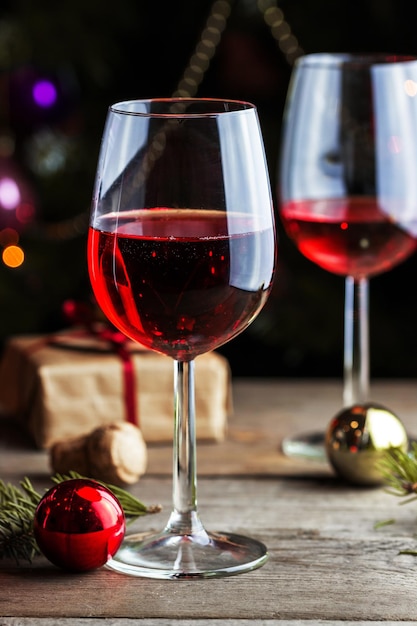 Glasses of wine with gift box and Christmas balls