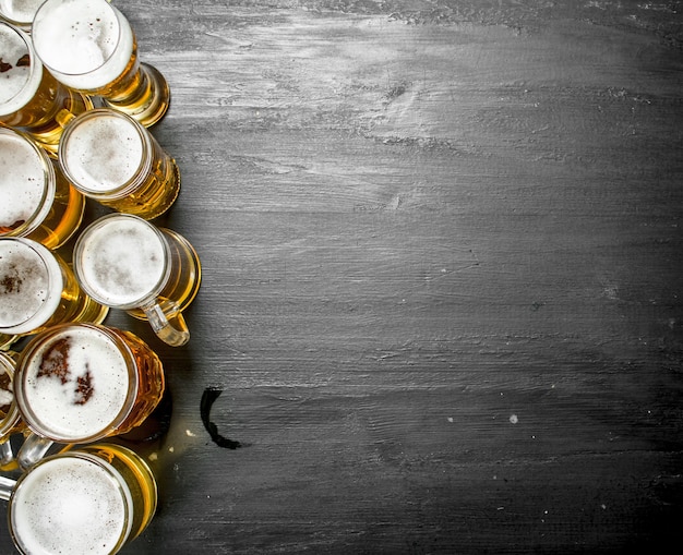 Glasses with beer. On the black chalkboard.