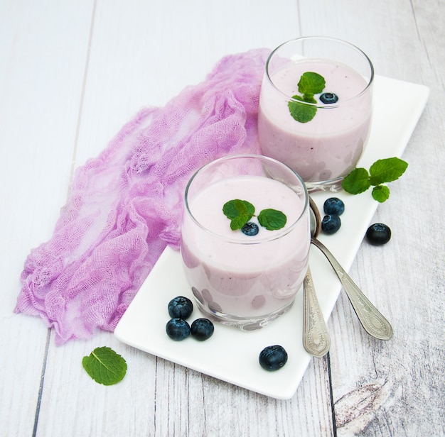 Glasses with blueberry yogurt on a table