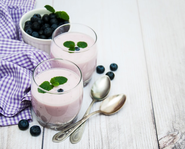 Glasses with blueberry yogurt on a table