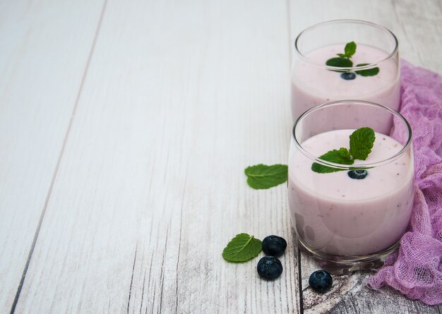 Glasses with blueberry yogurt on a table