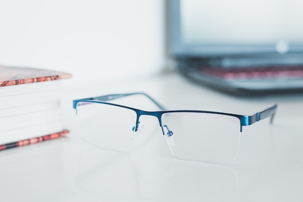 Photo glasses with book and laptop