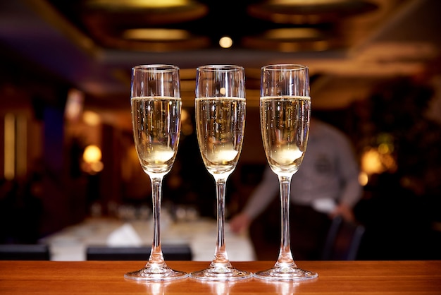 Glasses with champagne on the bar counter in a restaurant