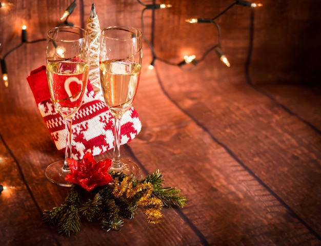 Glasses with champagne and christmas decoration background with space to write