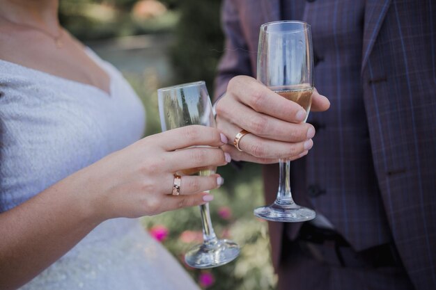 Glasses with champagne in the hands at wedding