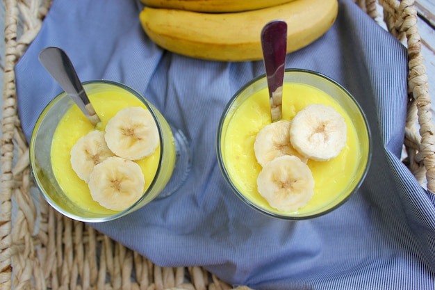 Glasses with delicious banana pudding on tray for breakfast