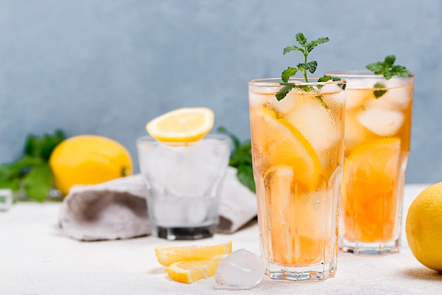 Glasses with fresh ice tea on table