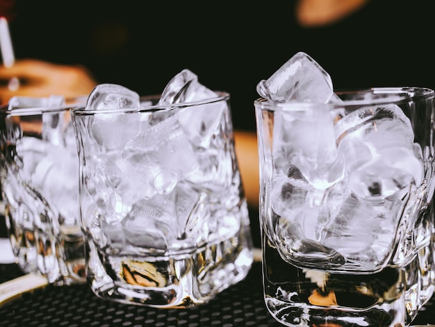 glasses with ice cubes are on the bar vintage photo processing