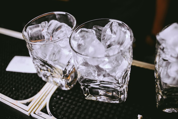 glasses with ice cubes are on the bar vintage photo processing