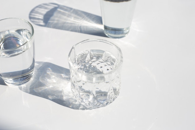 Glasses with water on white backgound.