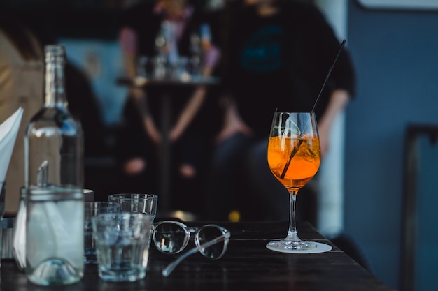 Glasses with wine and cocktail on the table in a cafe