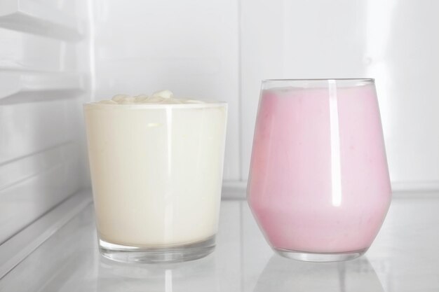 Glasses with yogurt standing in fridge