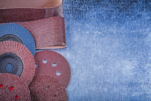 Glasspaper grinding discs abrasive flap wheels on metallic\
background