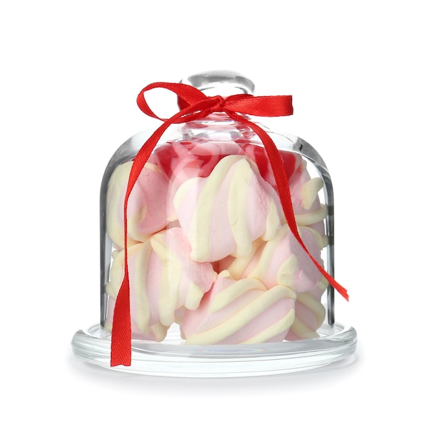 Glassware with colorful marshmallow candies on white background