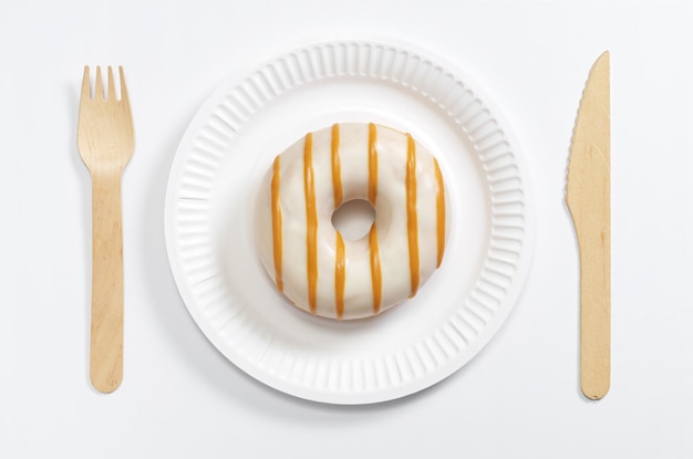 Glazed donut and cutlery