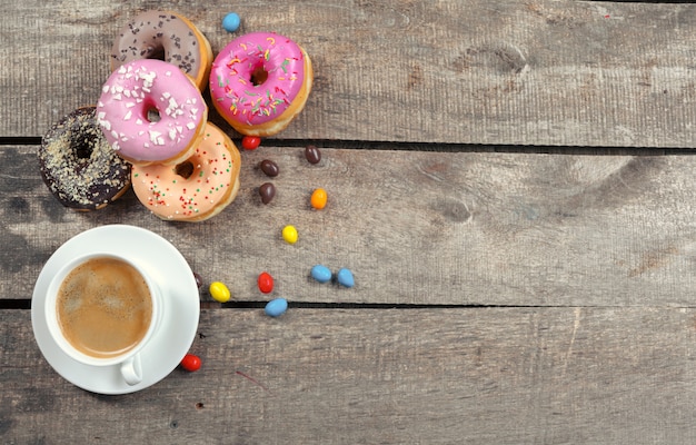 Glazed donuts on wooden background