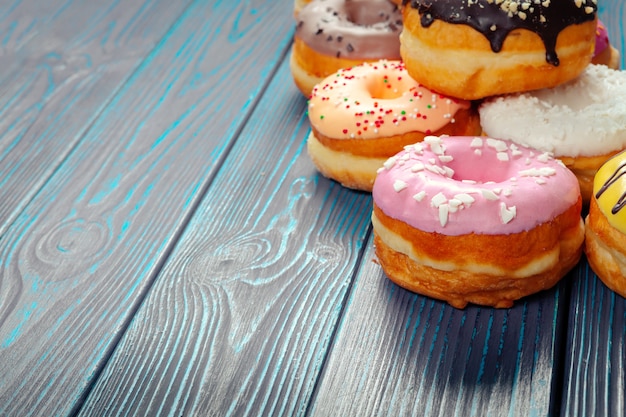 Glazed donuts on wooden background