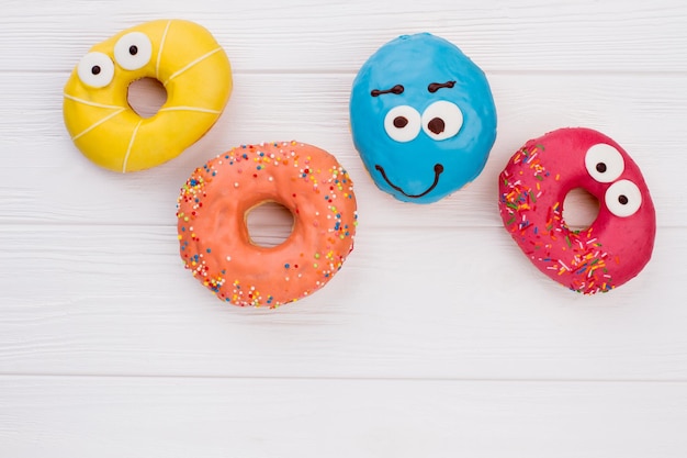 Glazed donuts on wooden background.