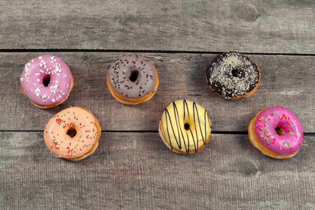 Glazed donuts on wooden surface