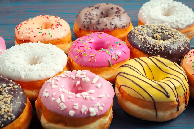 Glazed donuts on wooden surface