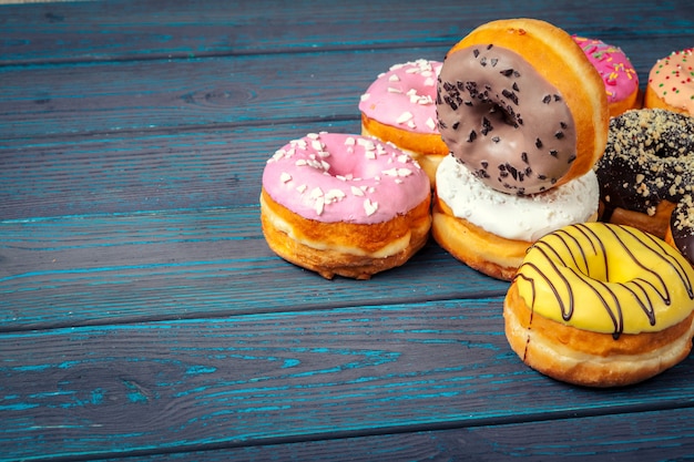 Glazed donuts on wooden surface