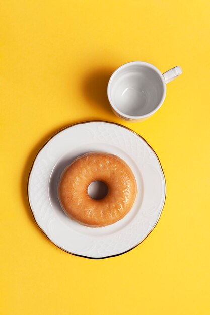 Glazed doughnuts on yellow background