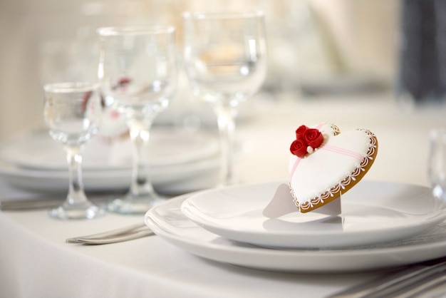 Glazed gingerbread on the served with white dishes table