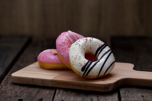 Glazed mini donuts on wooden background