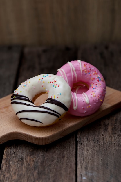 Glazed mini donuts on wooden background