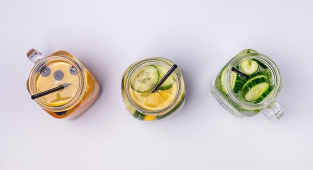 Glazen potten met vers gegoten water gemaakt met biologische groenten en fruit Gezonde detox-drank