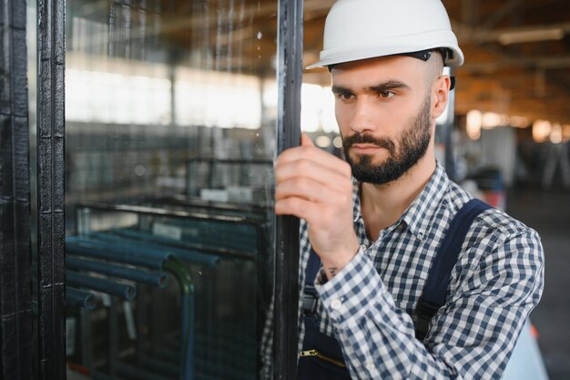 The glazier carries the glass in the glass factory