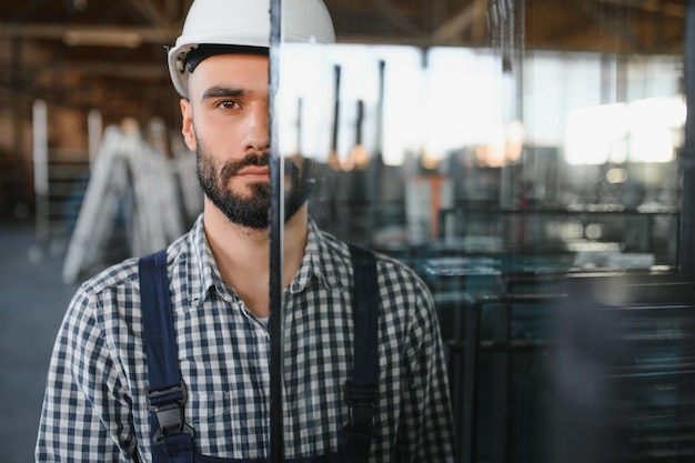 The glazier carries the glass in the glass factory