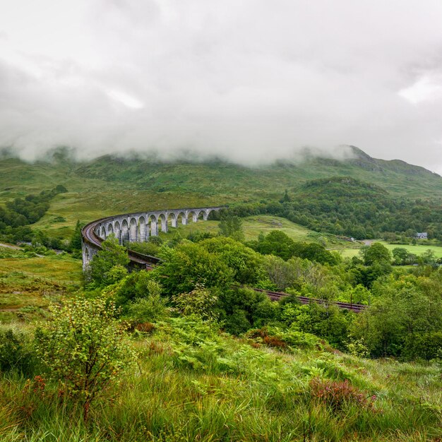 Glenfinnan viaduct in Scotland on overcast day.