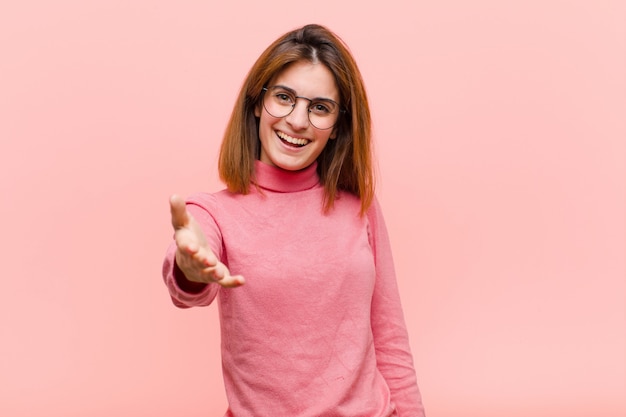 glimlachend, blij, zelfverzekerd en vriendelijk kijkend, een handdruk biedend om een deal te sluiten, meewerkend