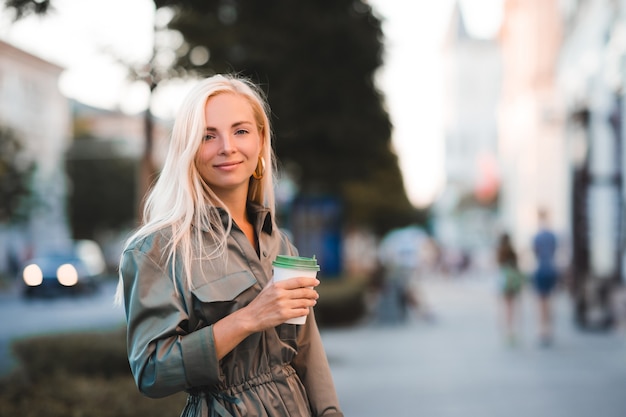 Glimlachend gelukkig mooi meisje koffie drinken