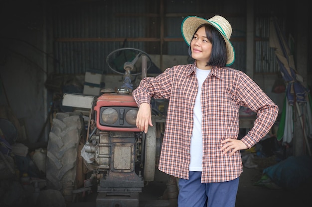 Glimlachende boerin naast een tractor