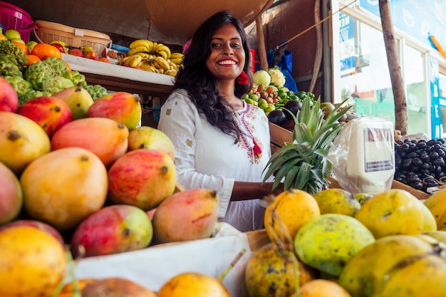 Glimlachende Indonesische zakenvrouw in Kerala Goa verkoopt groente- en fruitboerderij