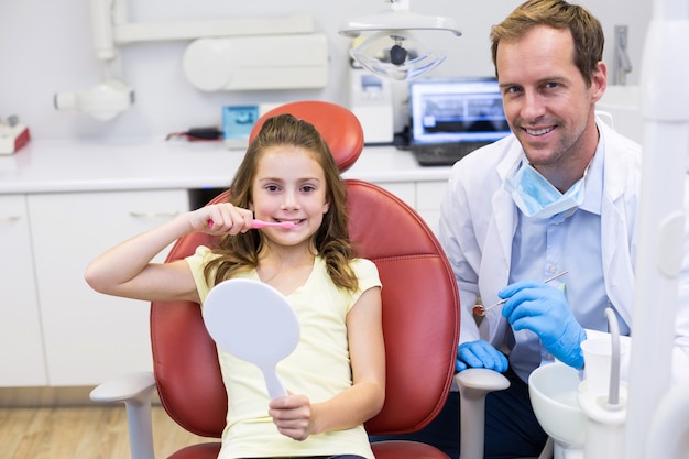 Glimlachende jonge patiënt met een tandarts in tandkliniek