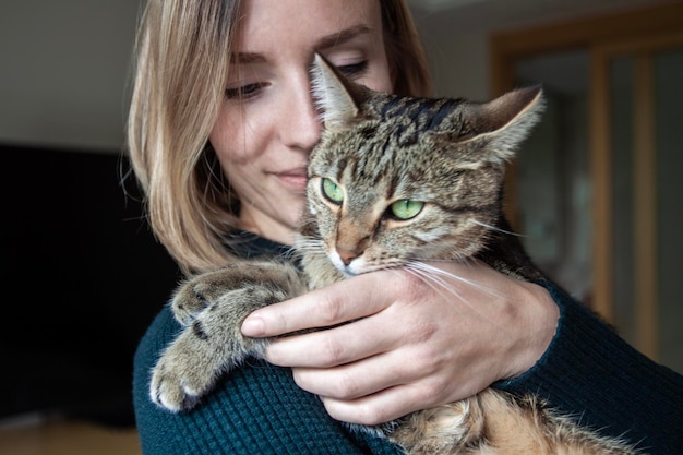 Foto glimlachende jonge vrouw met kat buiten