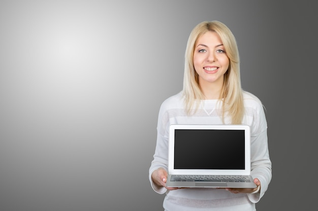 Glimlachende volwassen vrouw met laptop