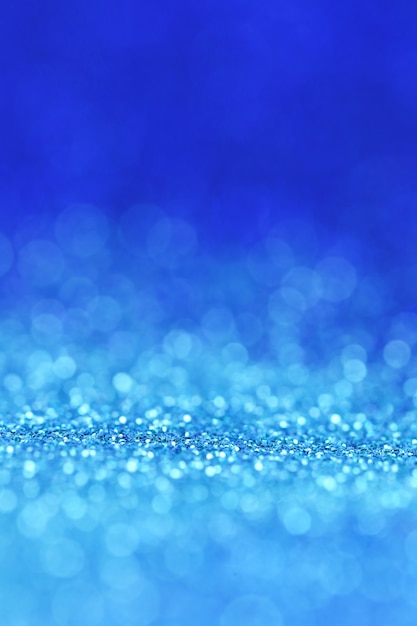 glitter blue background with light blue shining bokeh.