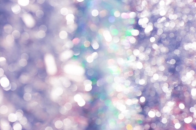 Glitter and bokeh of silver tinsel. Festive Christmas background.