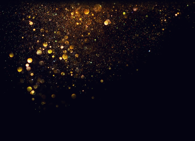 Glitter vintage lights background. gold and black. de focused