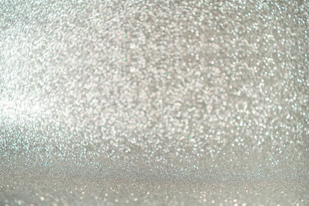 Glitter vintage lights background silver and light gold defocused