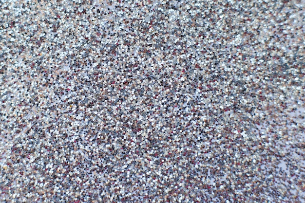 Glittering background of silver sequins closeup Sparkle festive texture