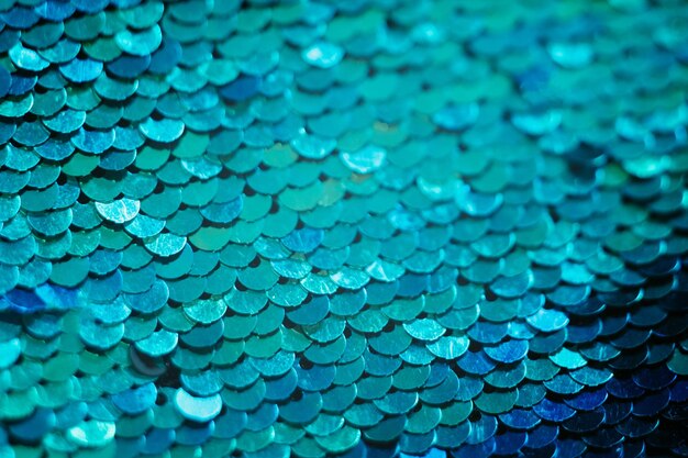 Glittering textile design Blue sequin background Mermaid scale concept