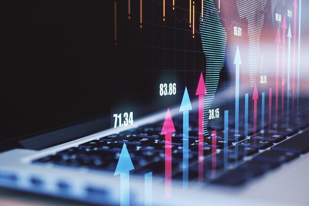 Global business and technology concept with laptop keyboard and digital financial arrows up