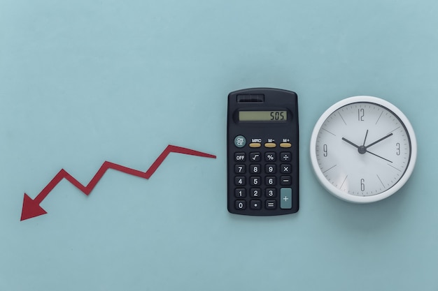 Global crisis theme. Calculator with clock, falling arrow tending down on blue