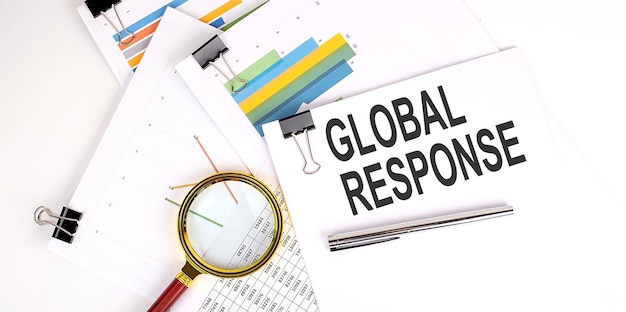 GLOBAL RESPONSE text on white paper on the light background with charts paper