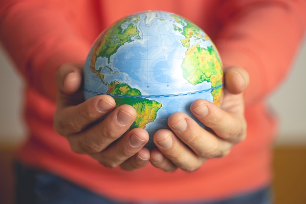 Globe of the Earth in the hands of a man.